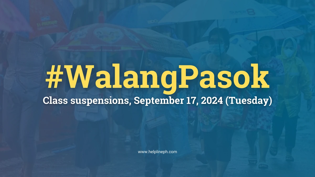 Students using umbrellas in heavy rain during class suspensions on September 17, 2024, due to severe weather in the Philippines.